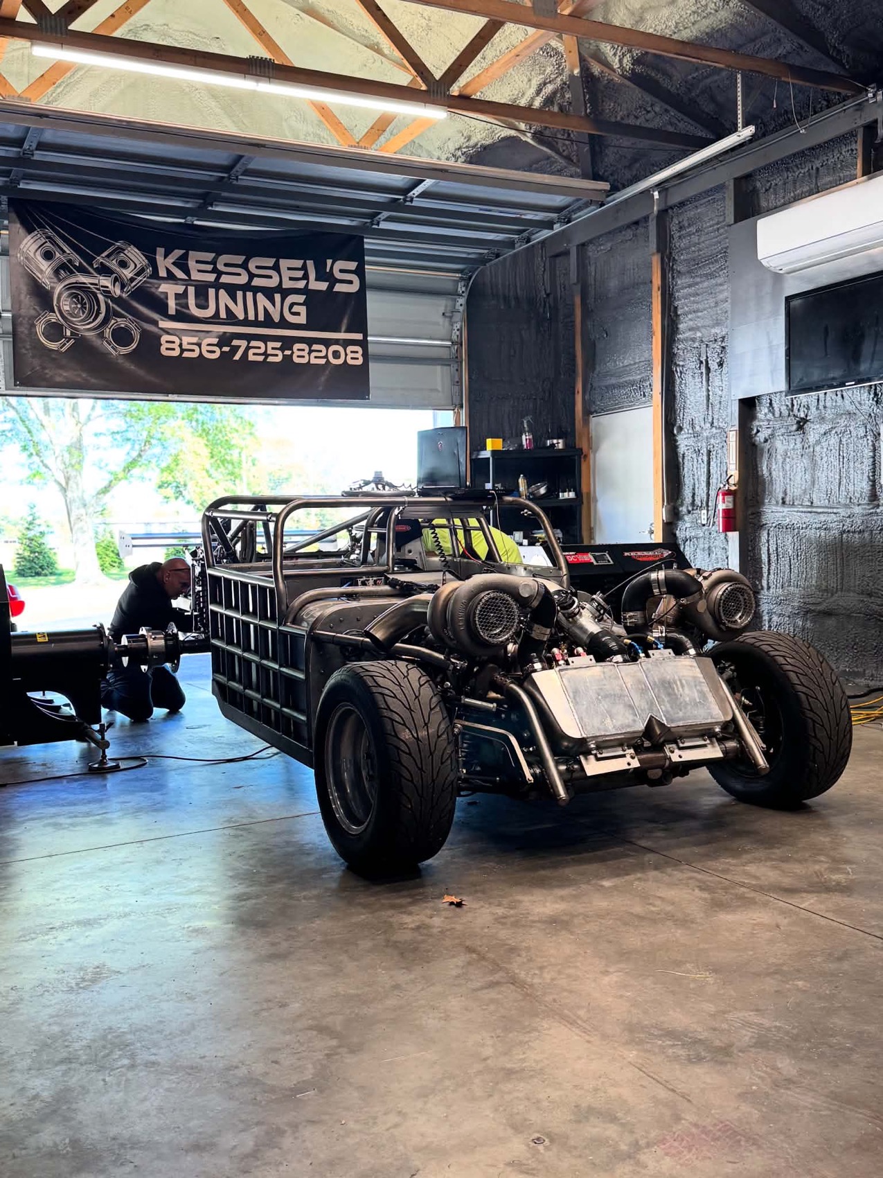 A twin turbo tube chassis car running standalone EFI in the shop